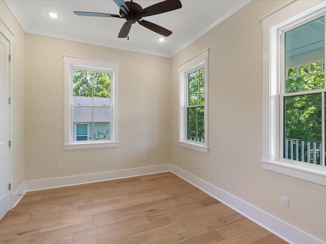 spare room featuring crown molding, recessed lighting, light wood-style floors, a ceiling fan, and baseboards