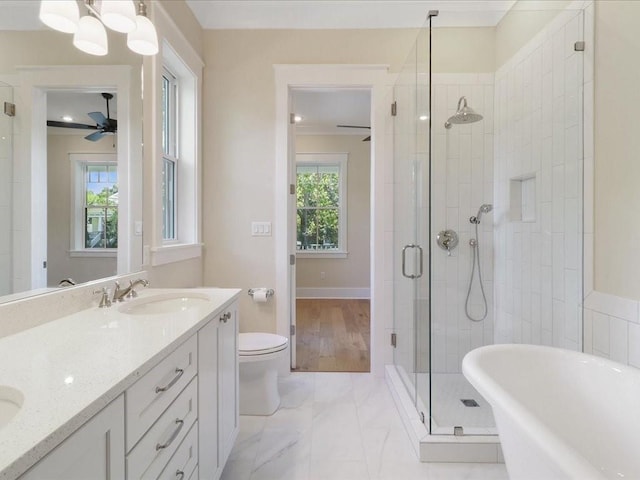 bathroom with double vanity, a soaking tub, ceiling fan, a shower stall, and a sink