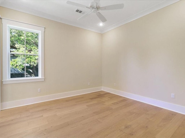 unfurnished room featuring a ceiling fan, baseboards, visible vents, and light wood finished floors