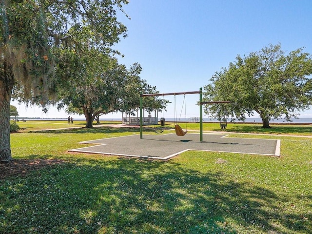 surrounding community featuring playground community and a lawn