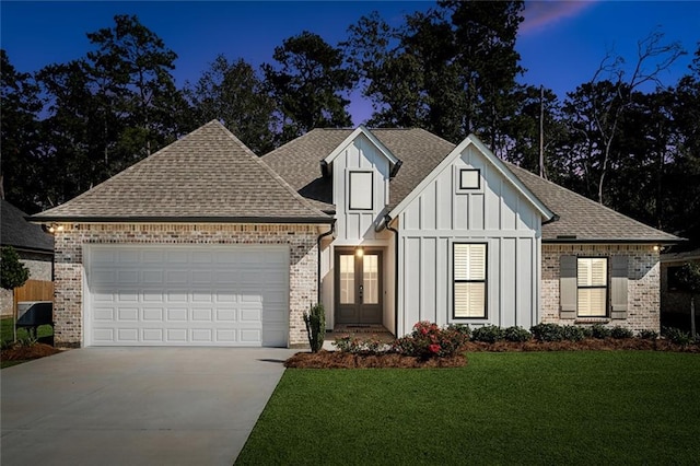 view of front of property with a lawn and a garage