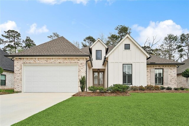 view of front of house with a garage and a front lawn