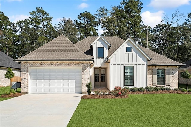 view of front of house with a garage, a front lawn, board and batten siding, and brick siding