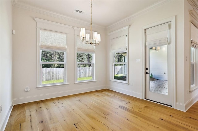 unfurnished dining area featuring light wood-type flooring, visible vents, and crown molding