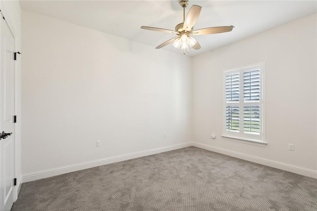 empty room featuring carpet floors, a ceiling fan, and baseboards