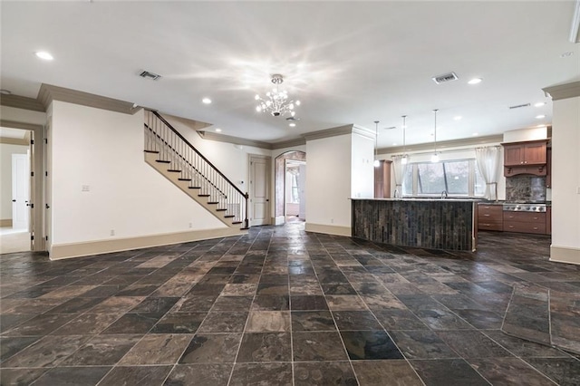 kitchen with decorative backsplash, ornamental molding, kitchen peninsula, stainless steel gas cooktop, and a chandelier