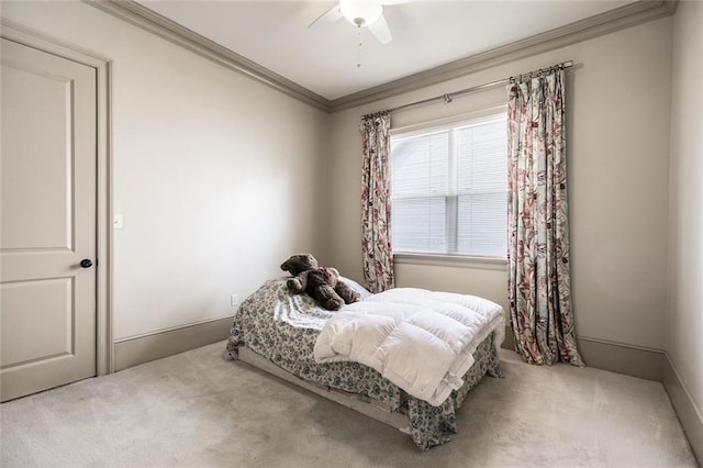 bedroom with ceiling fan, carpet floors, and ornamental molding