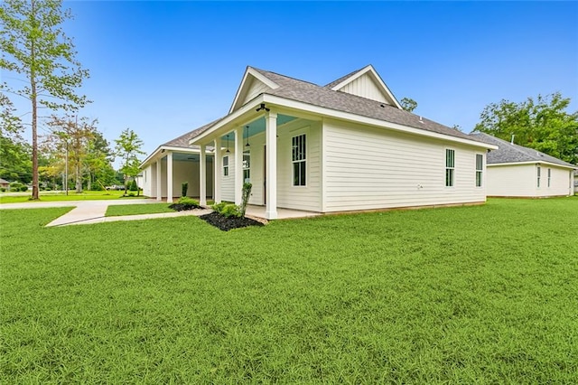 view of side of home with a yard