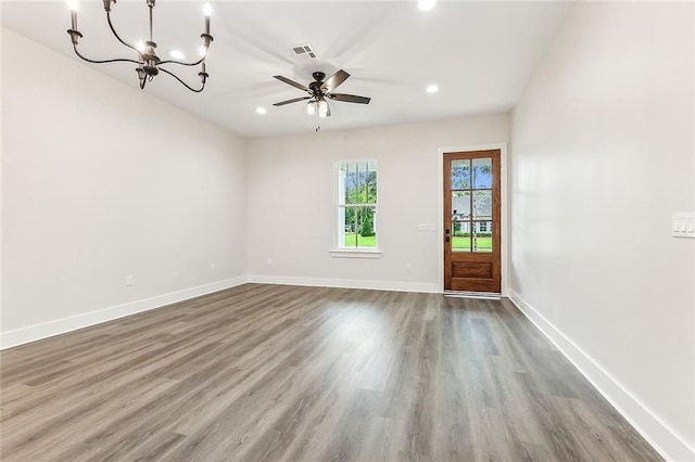 interior space featuring hardwood / wood-style flooring and ceiling fan with notable chandelier