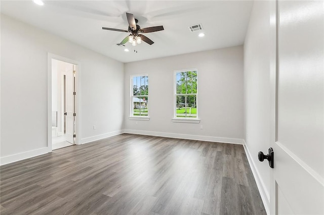 empty room featuring ceiling fan and dark hardwood / wood-style flooring