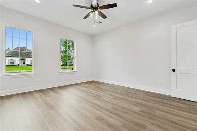 spare room featuring wood-type flooring and ceiling fan