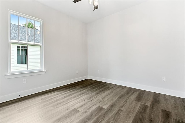 empty room with hardwood / wood-style floors and ceiling fan