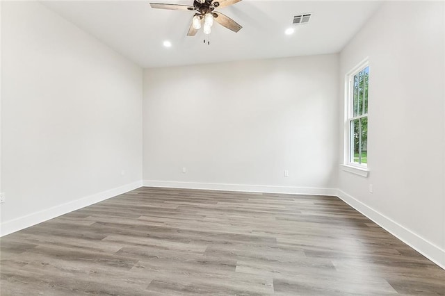 empty room featuring wood-type flooring and ceiling fan