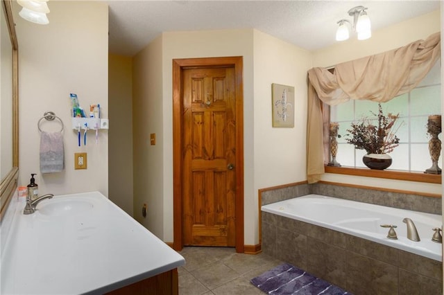 bathroom with vanity, tile patterned flooring, and tiled bath