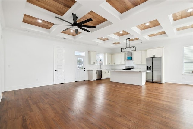 unfurnished living room featuring beam ceiling, coffered ceiling, ceiling fan, and dark hardwood / wood-style flooring