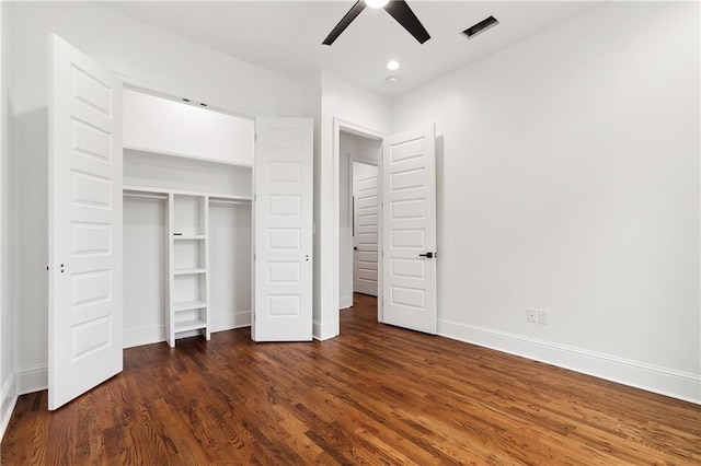 unfurnished bedroom with dark wood-type flooring, a closet, and ceiling fan