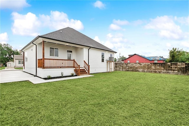 rear view of property featuring a patio and a lawn