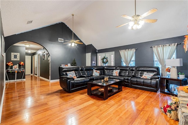 living room with high vaulted ceiling, wood-type flooring, and ceiling fan