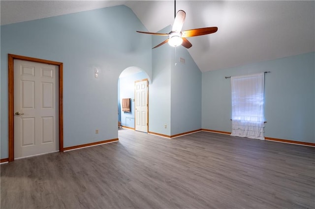 spare room with ceiling fan, high vaulted ceiling, and wood-type flooring