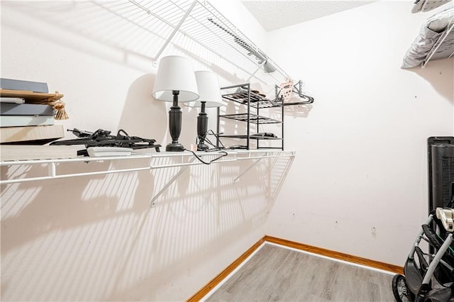 spacious closet featuring hardwood / wood-style floors