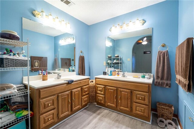 bathroom with vanity, hardwood / wood-style flooring, and ceiling fan