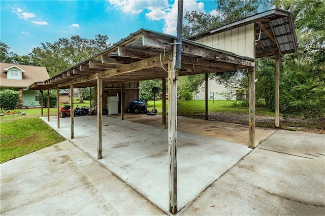 view of vehicle parking with a lawn and a carport