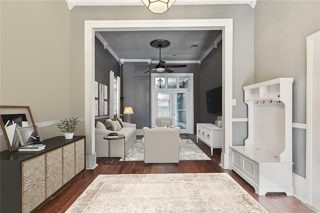 interior space with dark wood-type flooring, crown molding, and ceiling fan