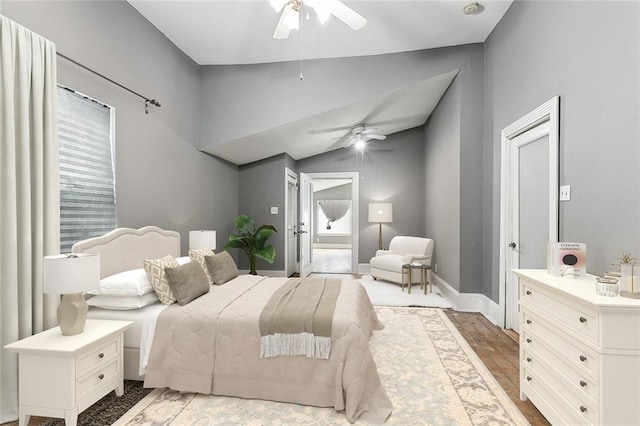 bedroom featuring lofted ceiling, hardwood / wood-style floors, and ceiling fan