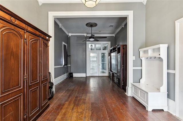 entryway featuring dark wood-type flooring, crown molding, and ceiling fan