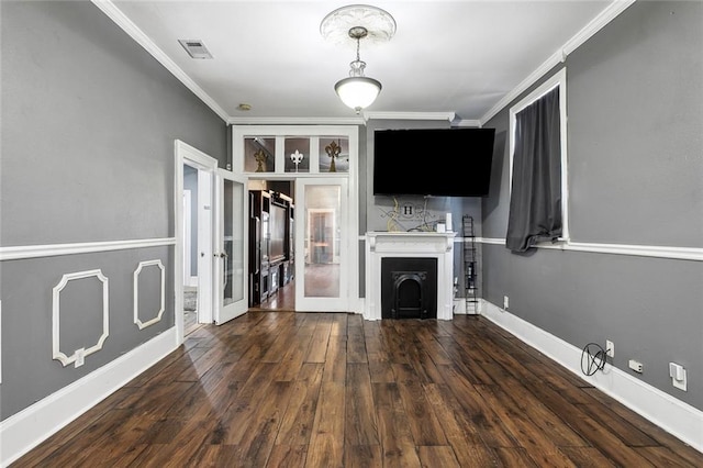 unfurnished living room featuring french doors, crown molding, and dark hardwood / wood-style floors