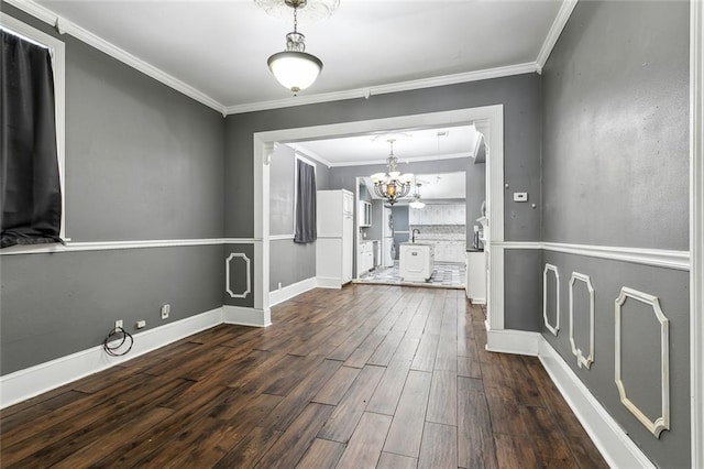 interior space featuring crown molding, a notable chandelier, and dark hardwood / wood-style flooring