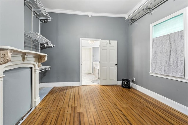 laundry area featuring ornamental molding, electric dryer hookup, and hardwood / wood-style flooring