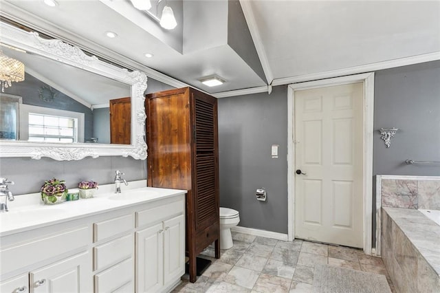 bathroom featuring tiled bath, toilet, lofted ceiling, vanity, and crown molding