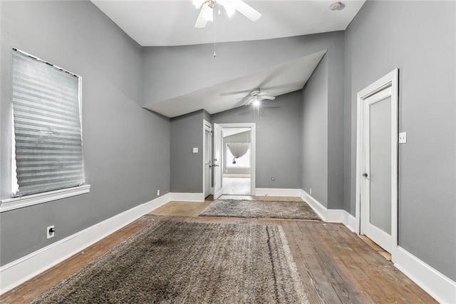 spare room featuring vaulted ceiling, wood-type flooring, and ceiling fan