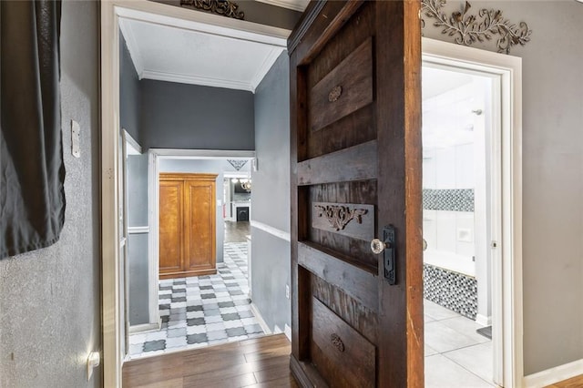 corridor with crown molding and light hardwood / wood-style floors