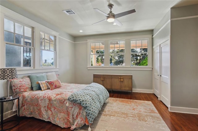 bedroom with dark wood-type flooring and ceiling fan