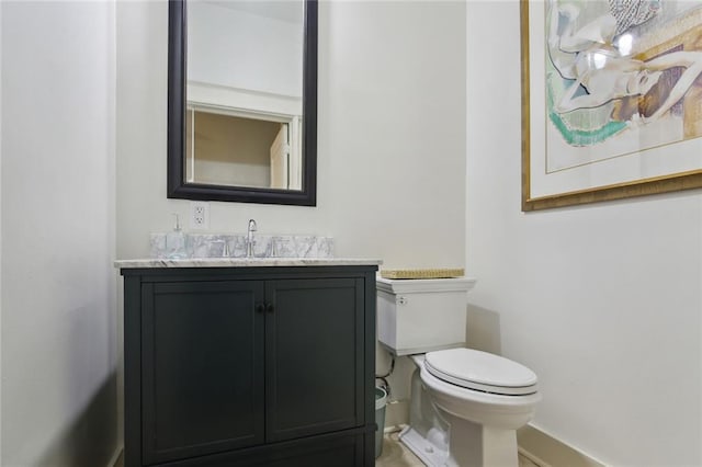 bathroom featuring toilet and vanity