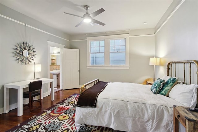 bedroom with dark wood-type flooring, ceiling fan, sink, and connected bathroom