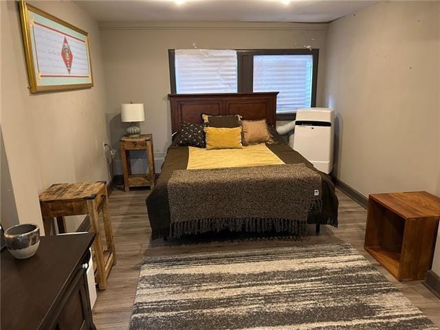 bedroom with hardwood / wood-style floors