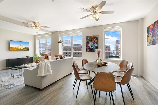 dining space with hardwood / wood-style flooring and ceiling fan