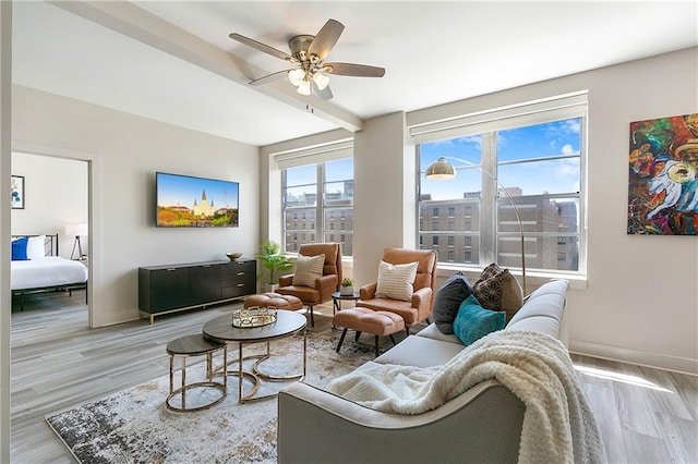 living room with light wood-type flooring and ceiling fan