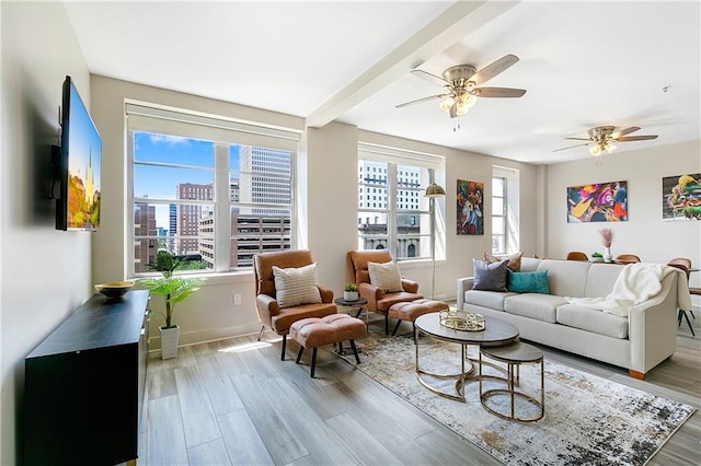 living room with ceiling fan and light hardwood / wood-style flooring