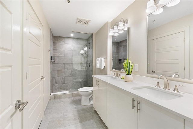 bathroom featuring vanity, toilet, and a shower with shower door