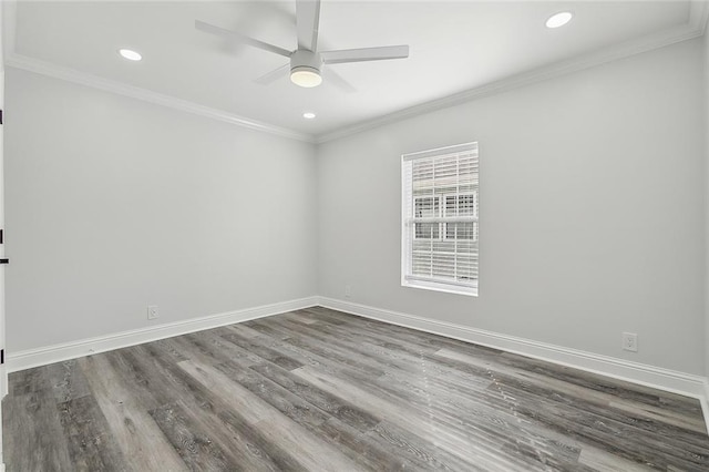 empty room featuring ornamental molding, dark wood-type flooring, and ceiling fan