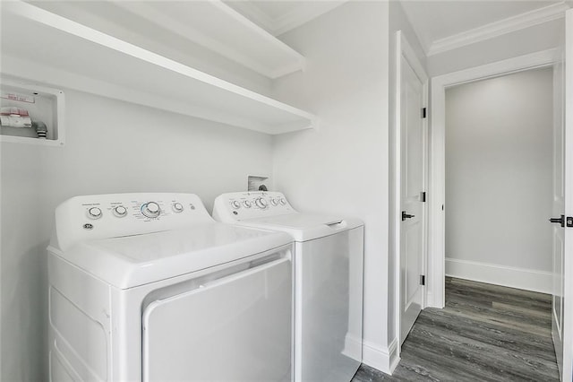 clothes washing area with crown molding, separate washer and dryer, and dark hardwood / wood-style floors