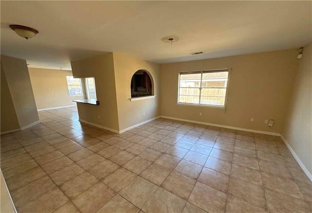 spare room featuring light tile patterned floors