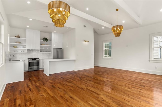 unfurnished living room with lofted ceiling with beams, sink, hardwood / wood-style floors, and a notable chandelier