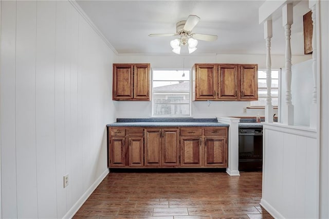 kitchen with dark hardwood / wood-style floors, ceiling fan, ornamental molding, and black dishwasher