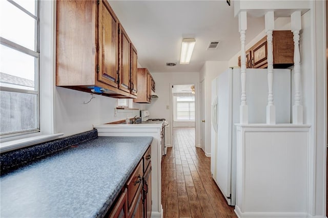 kitchen featuring white appliances and hardwood / wood-style flooring