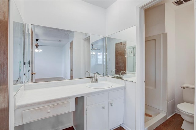 bathroom featuring hardwood / wood-style floors, vanity, ceiling fan, and toilet